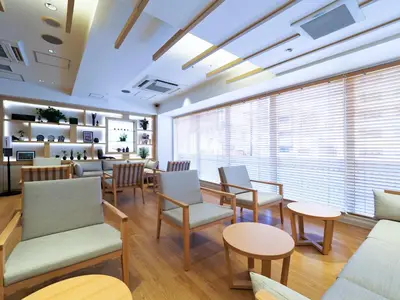 a waiting room with chairs and tables and windows at Far East Village Hotel Tokyo, Asakusa in Tokyo