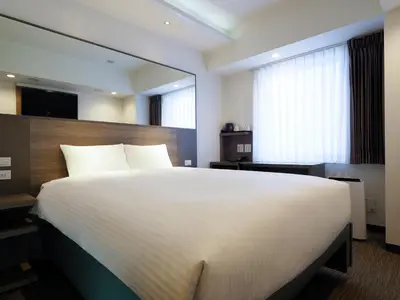 a bedroom with a large white bed and a window at Far East Village Hotel Tokyo, Asakusa in Tokyo