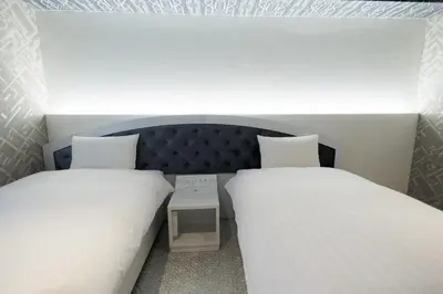 two beds in a small room with two bedsskirts at Hotaku HOTEL - Vacation STAY 98860v in Tokyo