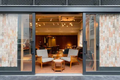 a glass window of a building with chairs and a table at OTHER SPACE Asakusa in Tokyo