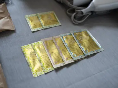 a group of gold packets sitting on a floor at OTHER SPACE Asakusa in Tokyo