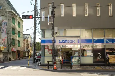 a traffic light on a city street with a law store at OTHER SPACE Asakusa in Tokyo