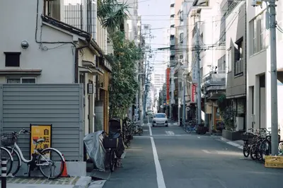 a city street with bikes parked on the sides of buildings at OTHER SPACE Asakusa in Tokyo