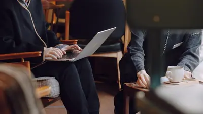 two people sitting in chairs with a laptop at OTHER SPACE Asakusa in Tokyo