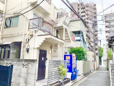 a building with a door and stairs in a street at KOSUMOSU Ikebukuro Shinjuku Private House in Tokyo
