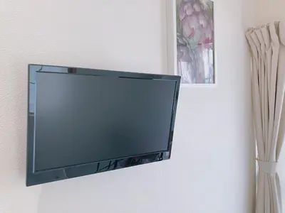 a flat screen tv hanging on a wall at KOSUMOSU Ikebukuro Shinjuku Private House in Tokyo