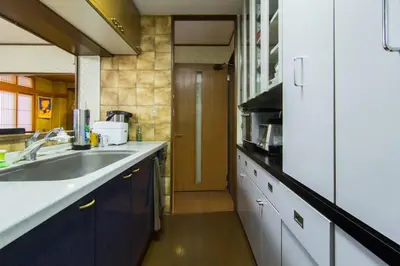 a kitchen with a sink and a counter top at Mochida's Guest House in Tokyo