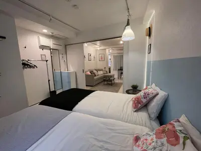 a bedroom with two beds and a living room at Hotel Ougien in Tokyo