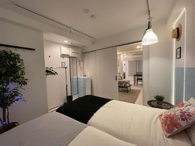 a bedroom with a bed and a living room at Hotel Ougien in Tokyo