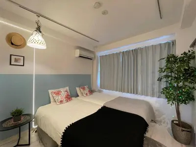 a bedroom with a bed in front of a window at Hotel Ougien in Tokyo