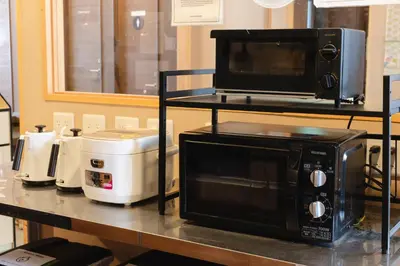 a counter with a microwave and a toaster oven on it at COGO Ryogoku in Tokyo