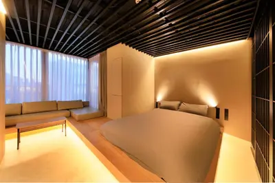 a living room with a bed and a couch at Amanecer Hotel in Tokyo