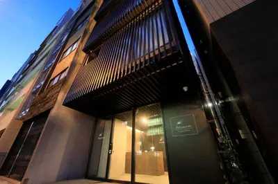 a building with large glass doors on the side of it at Amanecer Hotel in Tokyo