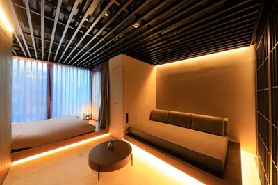 a bedroom with two beds and a table and a window at Amanecer Hotel in Tokyo
