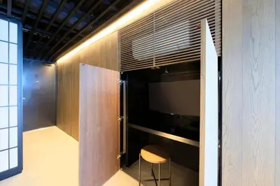 a room with a tv and a chair in it at Amanecer Hotel in Tokyo