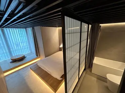 a small room with a bed and a window at Amanecer Hotel in Tokyo