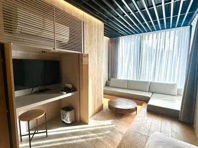 a living room with a couch and a large window at Amanecer Hotel in Tokyo