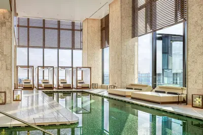 a hotel pool with beds and windows at Bvlgari Hotel Tokyo in Tokyo