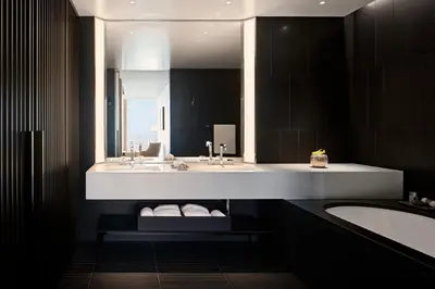a bathroom with two sinks and a tub and a mirror at Bvlgari Hotel Tokyo in Tokyo