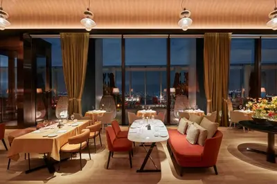 a restaurant with tables and chairs and a view of the city at Bvlgari Hotel Tokyo in Tokyo