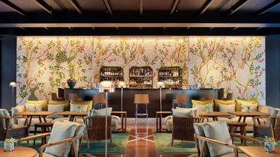 a restaurant with tables and chairs and a bar at Bvlgari Hotel Tokyo in Tokyo