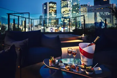 a table with a bottle of wine and two glasses at Hotel Indigo Tokyo Shibuya in Tokyo