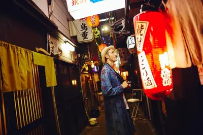 a man standing in front of a building in a street at Hotel Indigo Tokyo Shibuya in Tokyo