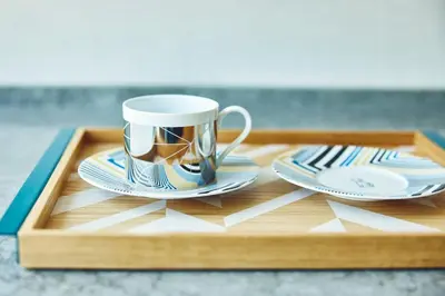 a wooden tray with a coffee mug and plates on it at Hotel Indigo Tokyo Shibuya in Tokyo