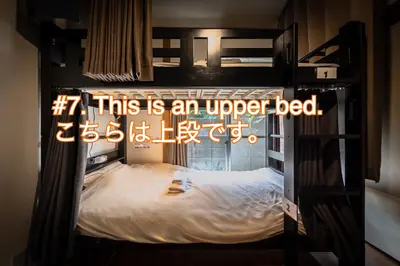 a sign that says this is an upper bed at Wabi Sabi Hostel in Tokyo