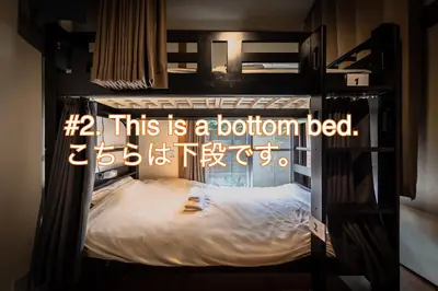 a bunk bed with a sign that says this is a bottom bed at Wabi Sabi Hostel in Tokyo