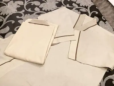 a pile of white towels sitting on a bed at HOTEL PARK SIDE in Tokyo
