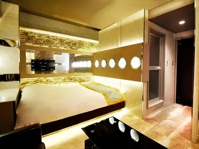 a room with a bed and a couch in it at HOTEL PARK SIDE in Tokyo