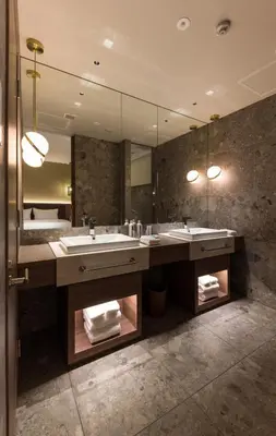 a bathroom with two sinks and a large mirror at THE skM TOKYO HOTEL & DINING in Tokyo