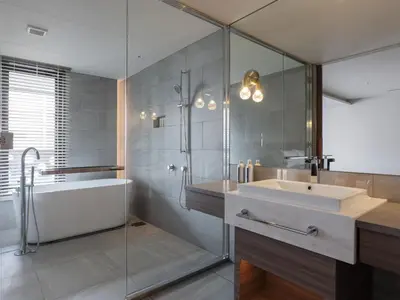 a bathroom with a sink and a shower and a tub at THE skM TOKYO HOTEL & DINING in Tokyo