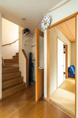 a hallway with stairs and a clock on the wall at \u30a2\u30f3\u30c9\u30b9\u30c6\u30a4\u897f\u65b0\u4e95 in Tokyo