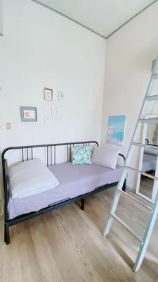 a bedroom with a bunk bed and a ladder at Rize Apartments in Tokyo