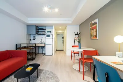 a living room with a red couch and a table at Section L Residence Ginza in Tokyo