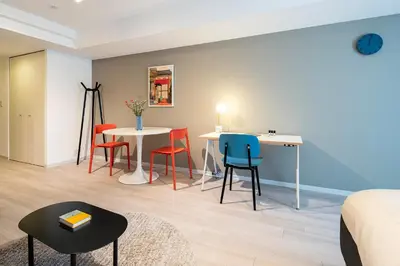 a living room with a table and chairs at Section L Residence Ginza in Tokyo