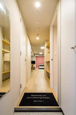 a hallway with a welcome mat on the floor at Section L Residence Ginza in Tokyo