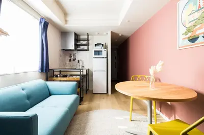 a living room with a blue couch and a table at Section L Residence Ginza in Tokyo