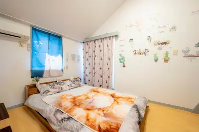 a bedroom with a large tiger blanket on the bed at Tokyo Shibuya Shinjyuku Cat House ! in Tokyo