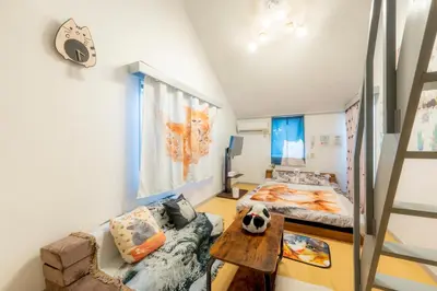 a small room with a bed and a couch at Tokyo Shibuya Shinjyuku Cat House ! in Tokyo
