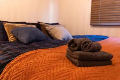 a pile of towels sitting on top of a bed at LiveGRACE Hotel Shibuya \u6e0b\u8c37\u897f\u65b0\u5bbf in Tokyo