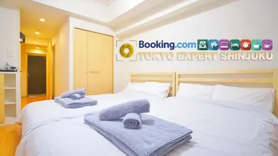 two beds in a hotel room with towels on them at TOKYO EXPERT SHINJUKU in Tokyo