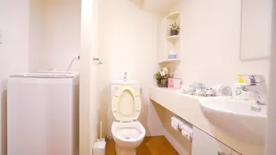 a white bathroom with a toilet and a sink at TOKYO EXPERT SHINJUKU in Tokyo