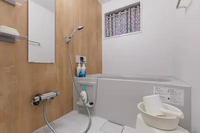 a bathroom with a shower and a toilet at EK House SkyTree in Tokyo