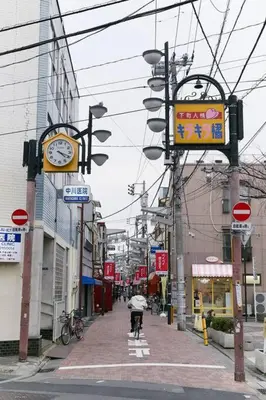 a person riding a bike down a city street at EK House SkyTree in Tokyo