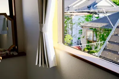 an open window with a view of a house at Shinjuku/Kabukichō｜Super Busy Area｜Cozy House｜85㎡ in Tokyo