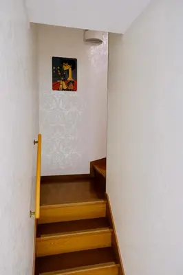 a staircase in a house with a painting on the wall at Shinjuku/Kabukichō｜Super Busy Area｜Cozy House｜85㎡ in Tokyo