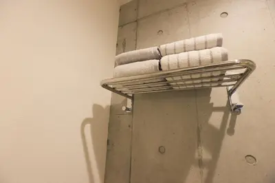 a towel rack with towels on it in a bathroom at Hotel Tabiya in Tokyo